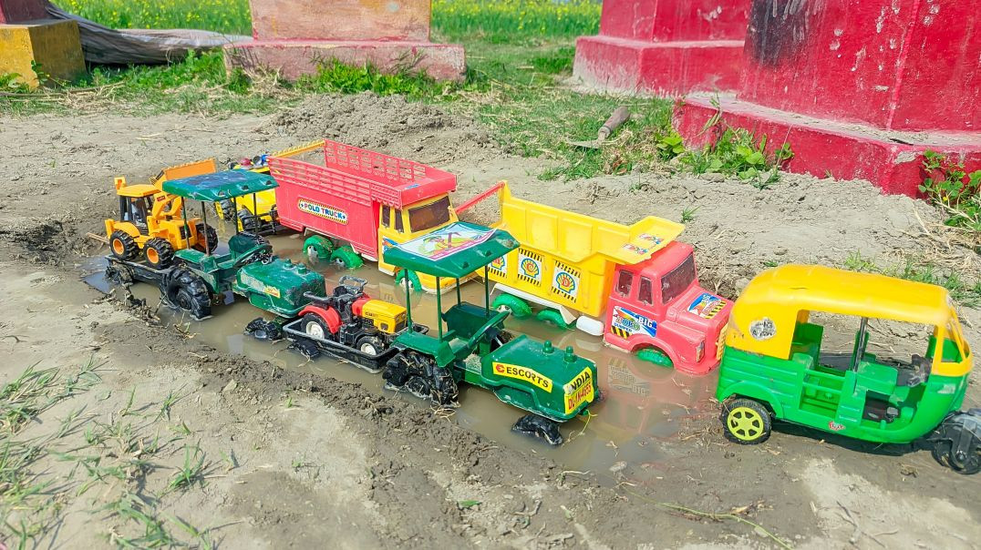 The title written on the yellow sticker of the green toy vehicle (tuk-tuk) is *“ESCORTS”*.