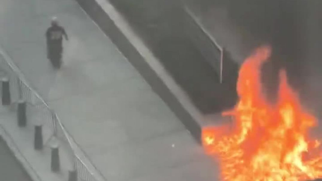 ⁣Person Caught On Camera Setting Fire Outside Federal Building In NYC